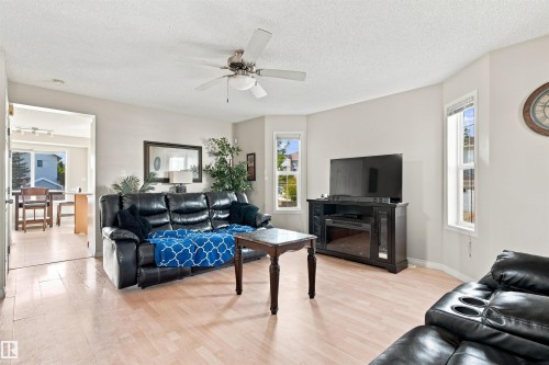 Recessed lighting, light wood-finish flooring, ceiling fan, bay windows, and neutral wall paint - 204 84 Street Sw, Edmonton, AB - Indoor Photo Showing Living Room