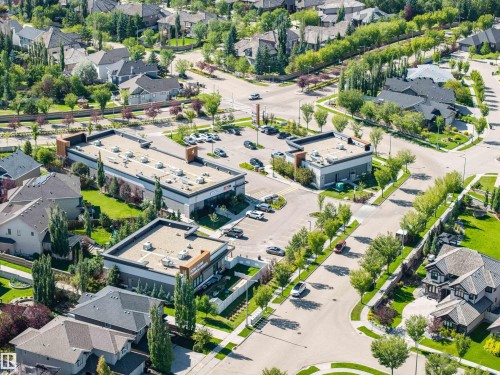 Residential neighborhood featuring broad streets, mature trees, and nearby commercial buildings - 2043 Cameron Ravine Way Nw, Edmonton, AB - Outdoor With View