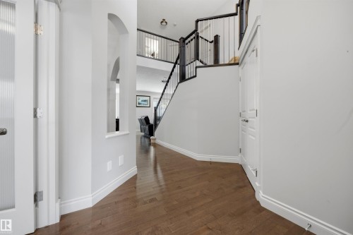 Wood-finish flooring throughout the entry - 2043 Cameron Ravine Way Nw, Edmonton, AB - Indoor Photo Showing Other Room