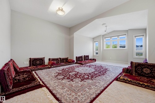 Expansive room featuring high ceilings and an arched entryway - 2043 Cameron Ravine Way Nw, Edmonton, AB - Indoor