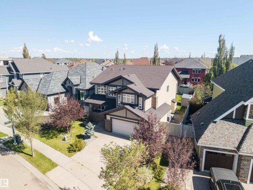 Two-story residence with a two-tone facade, attached front-facing garage, and concrete driveway - 2043 Cameron Ravine Way Nw, Edmonton, AB - Outdoor
