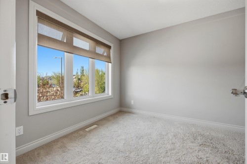 Multi-pane window with roller shades - 2043 Cameron Ravine Way Nw, Edmonton, AB - Indoor Photo Showing Other Room