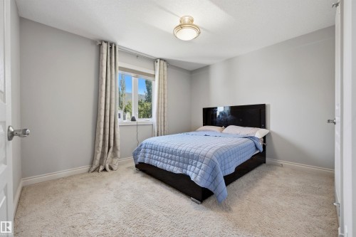 Plush carpeting, neutral wall color, and a flush mount ceiling light - 2043 Cameron Ravine Way Nw, Edmonton, AB - Indoor Photo Showing Bedroom