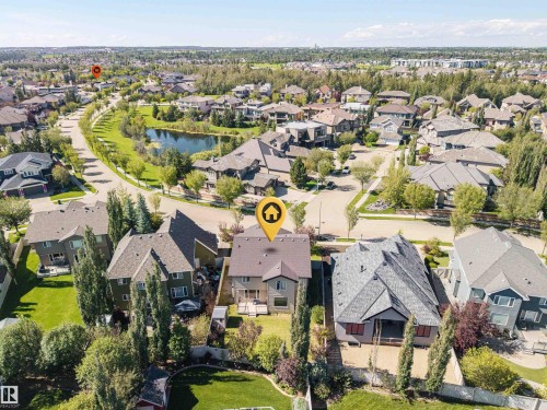 Residential neighborhood with mature trees, paved roads, and a central pond - 2043 Cameron Ravine Way Nw, Edmonton, AB - Outdoor With View