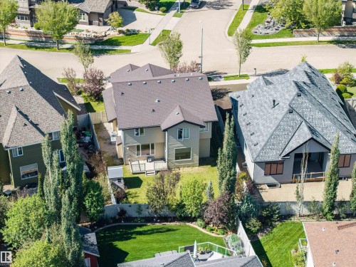 Well-maintained streetscape, mature landscaping, paved road, and established residential structures - 2043 Cameron Ravine Way Nw, Edmonton, AB - Outdoor