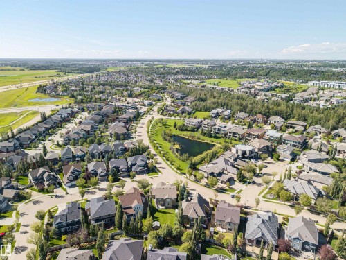 Expansive residential neighborhood featuring numerous properties, green spaces, and a central pond - 2043 Cameron Ravine Way Nw, Edmonton, AB - Outdoor With View