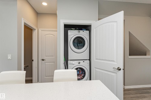 Dedicated laundry closet featuring stacked appliances - #61 215 Saddleback Rd Nw, Edmonton, AB - Indoor Photo Showing Laundry Room