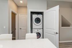 Dedicated laundry closet featuring stacked appliances - 