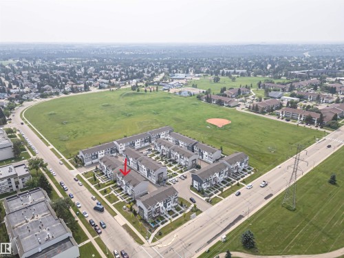 Townhome property situated directly across from an expansive green space with a baseball diamond - #61 215 Saddleback Rd Nw, Edmonton, AB -  With View