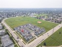 Townhome property situated directly across from an expansive green space with a baseball diamond - #61 215 Saddleback Rd Nw, Edmonton, AB  -  With View 