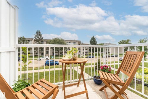 Private balcony featuring white railing, concrete flooring, and a partial privacy wall - #61 215 Saddleback Rd Nw, Edmonton, AB - Outdoor With Deck Patio Veranda