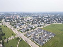 Aerial perspective showcasing a developed urban area with varied residential and commercial structures - 