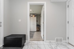 White marble-look floor tiles complement the light gray wall paint - 