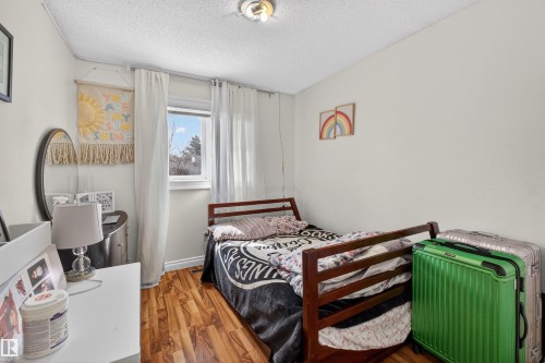 Wood-finish flooring, white walls, and a window with white window treatments - 9007 169 Avenue Nw, Edmonton, AB - Indoor Photo Showing Bedroom