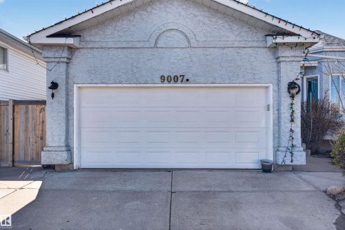 Attached single-car garage featuring a white paneled door - 9007 169 Avenue Nw, Edmonton, AB - Outdoor