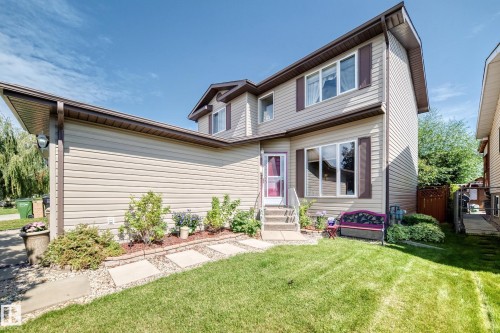 Two-story home with horizontal siding, multiple windows, and a covered front entry - 13069 37 Street Nw, Edmonton, AB - Outdoor