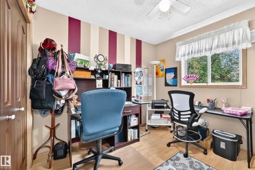Wood-finish flooring with a ceiling fan light fixture - 13069 37 Street Nw, Edmonton, AB - Indoor Photo Showing Office