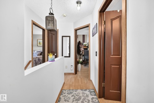 Wood-finish flooring throughout, white walls, and a recessed ceiling light fixture - 13069 37 Street Nw, Edmonton, AB - Indoor Photo Showing Other Room