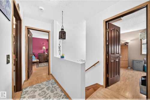 Wood-finish flooring with solid wood doors - 13069 37 Street Nw, Edmonton, AB - Indoor Photo Showing Other Room