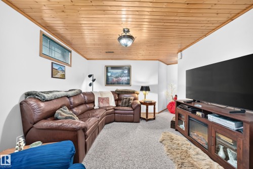 Wood-paneled ceiling with a central flush-mount light fixture - 13069 37 Street Nw, Edmonton, AB - Indoor Photo Showing Other Room
