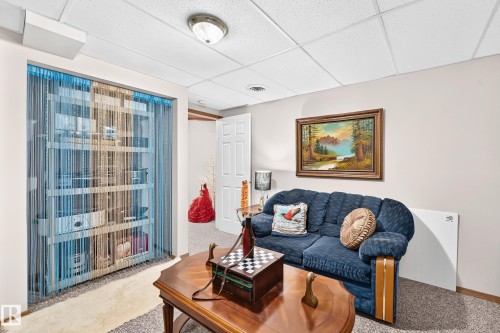 Recessed ceiling lighting illuminates the space, featuring a drop-panel ceiling - 13069 37 Street Nw, Edmonton, AB - Indoor Photo Showing Living Room