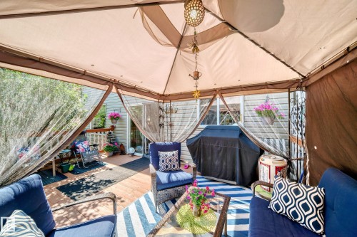 Spacious outdoor deck featuring wood-finish flooring, a gazebo canopy, and a sliding glass door entry - 13069 37 Street Nw, Edmonton, AB -  Photo Showing Other Room
