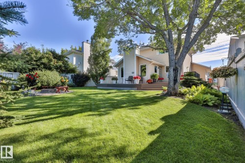 The expansive private fenced yard features loads of mature trees, shrubs & flower beds, huge multi-level deck, fire pit area and large shed - 3764 30 Street Nw, Edmonton, AB - Outdoor
