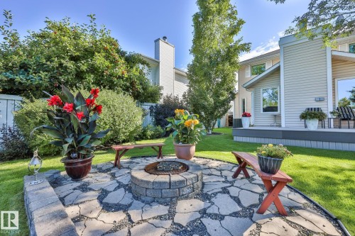 Stone paver patio featuring a built-in fire pit with an integrated stone block surround - 3764 30 Street Nw, Edmonton, AB - Outdoor With Deck Patio Veranda
