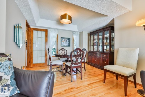 Recessed ceiling with an overhead light fixture, birch hardwood flooring, and French doors with frosted glass - 3764 30 Street Nw, Edmonton, AB - Indoor