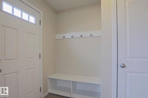 Entryway mudroom with a built-in bench, storage cubbies, and wall-mounted coat hooks - 308 Watt Boulevard Sw, Edmonton, AB - Indoor Photo Showing Other Room