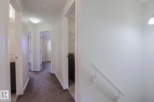 Hallway with recessed lighting, textured ceilings, white trim, and gray carpet flooring - 308 Watt Boulevard Sw, Edmonton, AB - Indoor Photo Showing Other Room