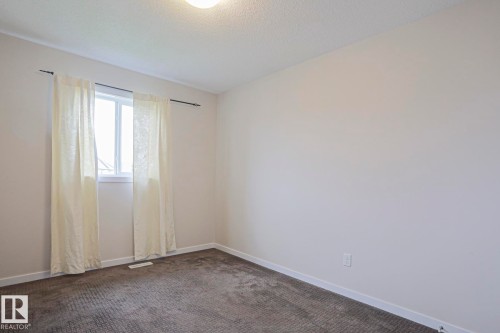 Room with neutral wall paint, white trim, and textured carpeting - 308 Watt Boulevard Sw, Edmonton, AB - Indoor Photo Showing Other Room