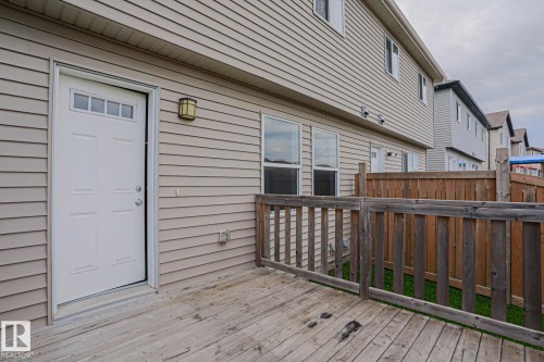 Exterior deck with wood fencing, vinyl siding, and transom window door - 308 Watt Boulevard Sw, Edmonton, AB - Outdoor With Exterior