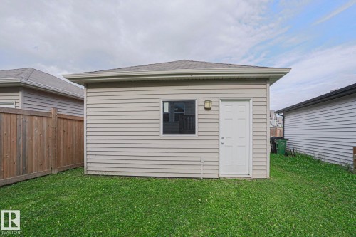 Detached structure with horizontal siding, a single window, an exterior door, and an attached outdoor light fixture - 308 Watt Boulevard Sw, Edmonton, AB - Outdoor With Exterior