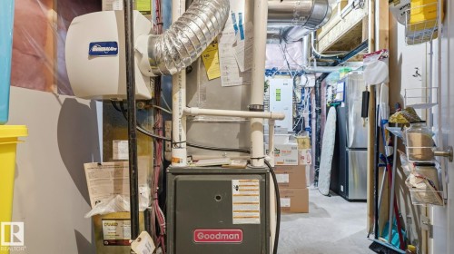 Goodman furnace and humidifier system with visible ductwork and piping - 731 36 Street Sw, Edmonton, AB - Indoor Photo Showing Basement