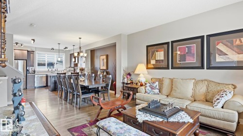 Open-concept living area featuring wood-finish flooring - 731 36 Street Sw, Edmonton, AB - Indoor Photo Showing Living Room