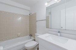 White vanity with an integrated sink and chrome faucet - 