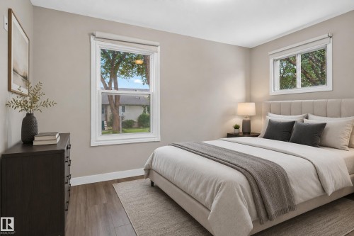 Wood-finish flooring, light neutral wall color, and multiple windows with white trim - 11549 88 Street Nw, Edmonton, AB - Indoor Photo Showing Bedroom