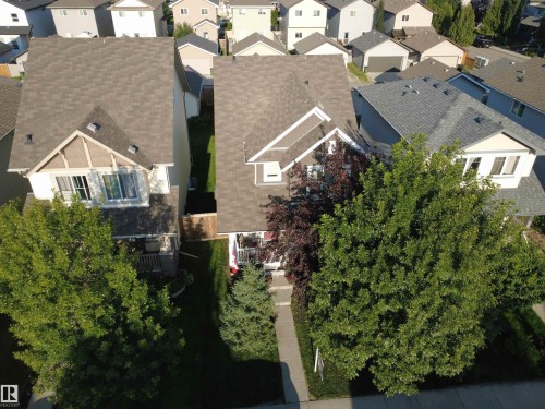 Gable roofline with dormer accent, covered front porch, established landscaping, and paved walkway - 7065 Cardinal Way Sw, Edmonton, AB - Outdoor