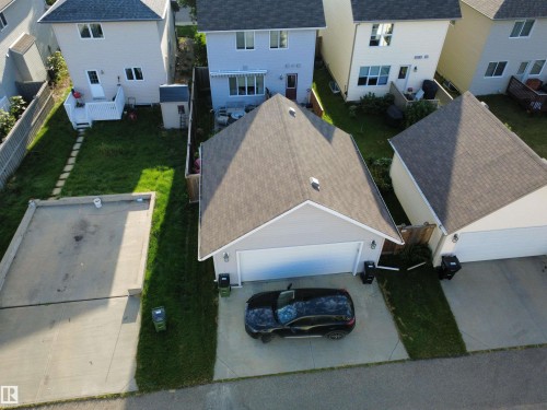 Attached garage with a paved driveway - 7065 Cardinal Way Sw, Edmonton, AB - Outdoor