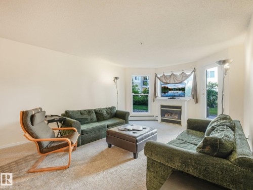 #114 10511 42 Av Nw, Edmonton, AB - Indoor Photo Showing Living Room With Fireplace