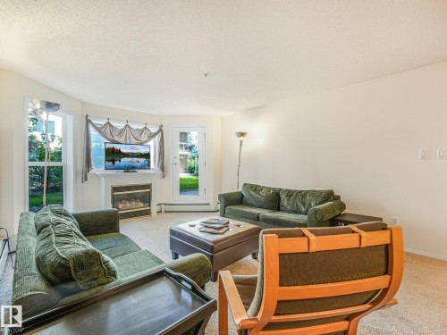 #114 10511 42 Av Nw, Edmonton, AB - Indoor Photo Showing Living Room With Fireplace