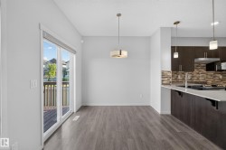 Wood-finish flooring throughout, with a contemporary drum pendant light fixture - 
