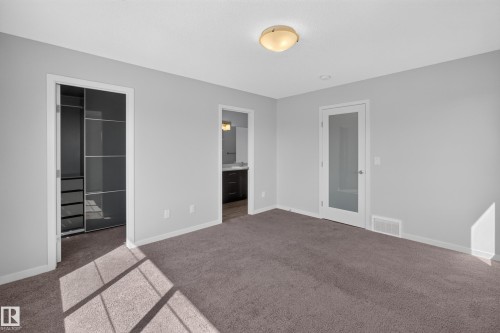 Plush carpeting with light gray walls - 1404 25 Avenue Nw, Edmonton, AB - Indoor Photo Showing Other Room