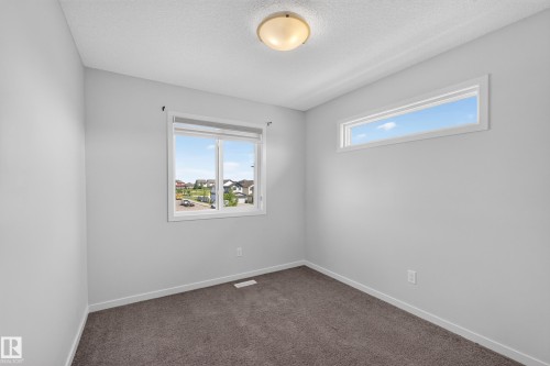 Carpeted flooring, white trim, recessed lighting, and dual windows - 1404 25 Avenue Nw, Edmonton, AB - Indoor Photo Showing Other Room