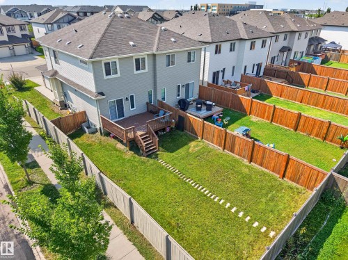 Spacious backyard featuring a wood deck with stairs, a sliding glass door entry, and a full wood privacy fence - 1404 25 Avenue Nw, Edmonton, AB - Outdoor With Exterior