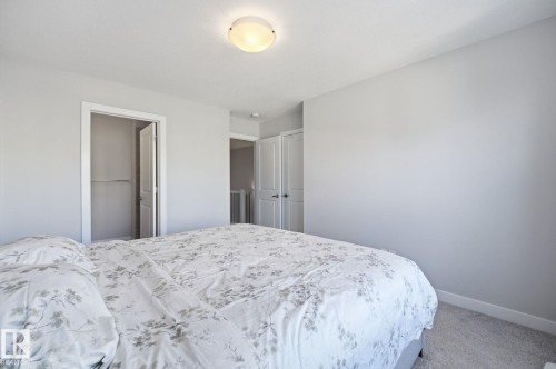 Primary bedroom with a private ensuite and walk-in closet. - 1793 Keene Crescent Sw, Edmonton, AB - Indoor Photo Showing Bedroom