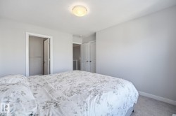 Primary bedroom with a private ensuite and walk-in closet. - 