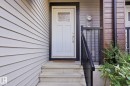 Light gray horizontal siding with a white panel door and clear glass insert - 1793 Keene Crescent Sw, Edmonton, AB 