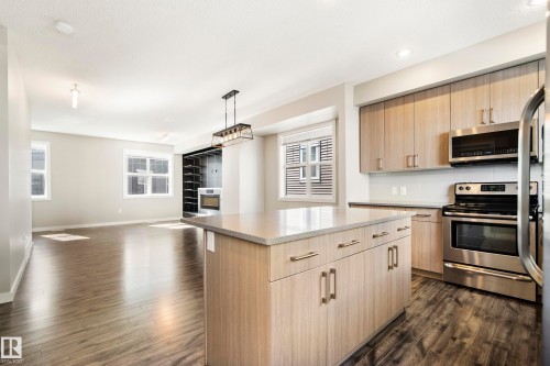 Spacious Kitchen with Large Island - #82 2803 James Mowatt Trail Sw, Edmonton, AB - Indoor Photo Showing Kitchen With Stainless Steel Kitchen